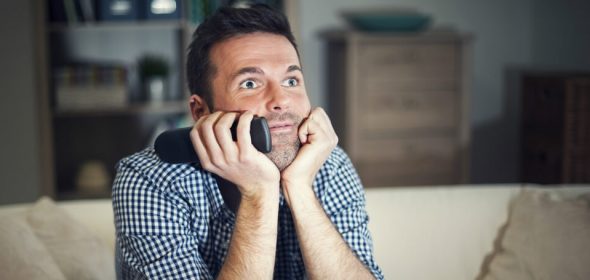 man watching tv with interest