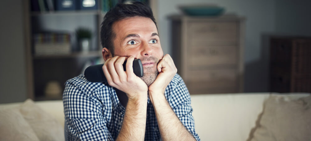 man watching tv with interest